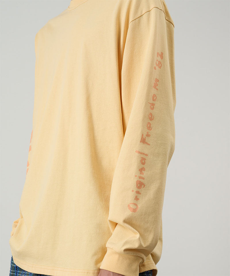 Yellow long-sleeve shirt with text on sleeve against a gray background