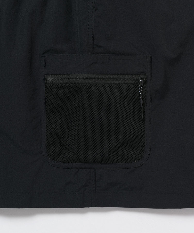 Close-up of Gramicci Guide Skort pocket in the color black against a light-tone background.