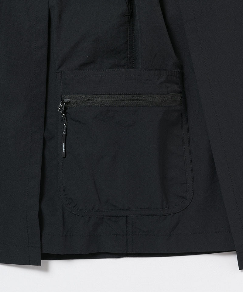 Close-up of Gramicci Guide Skort pocket in the color black against a light-tone background.