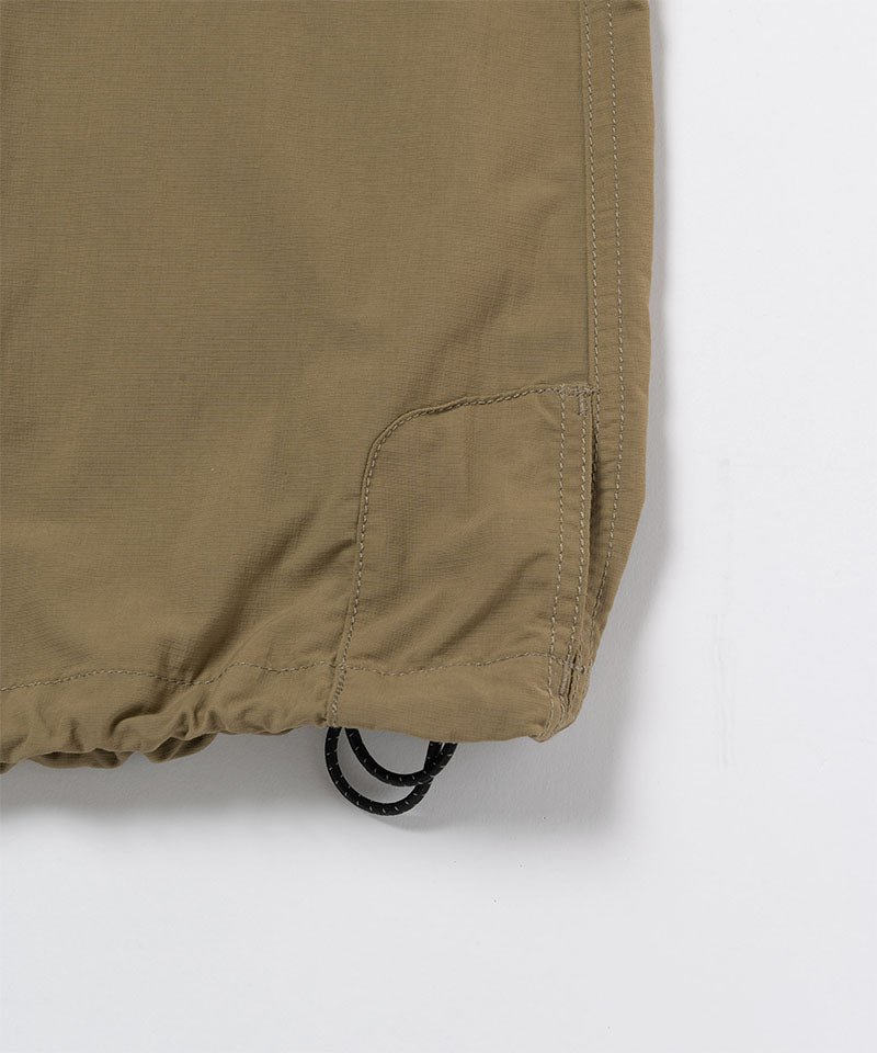 Close-up of Gramicci Convertible Cargo Skirt in the color khaki against a light-tone background.