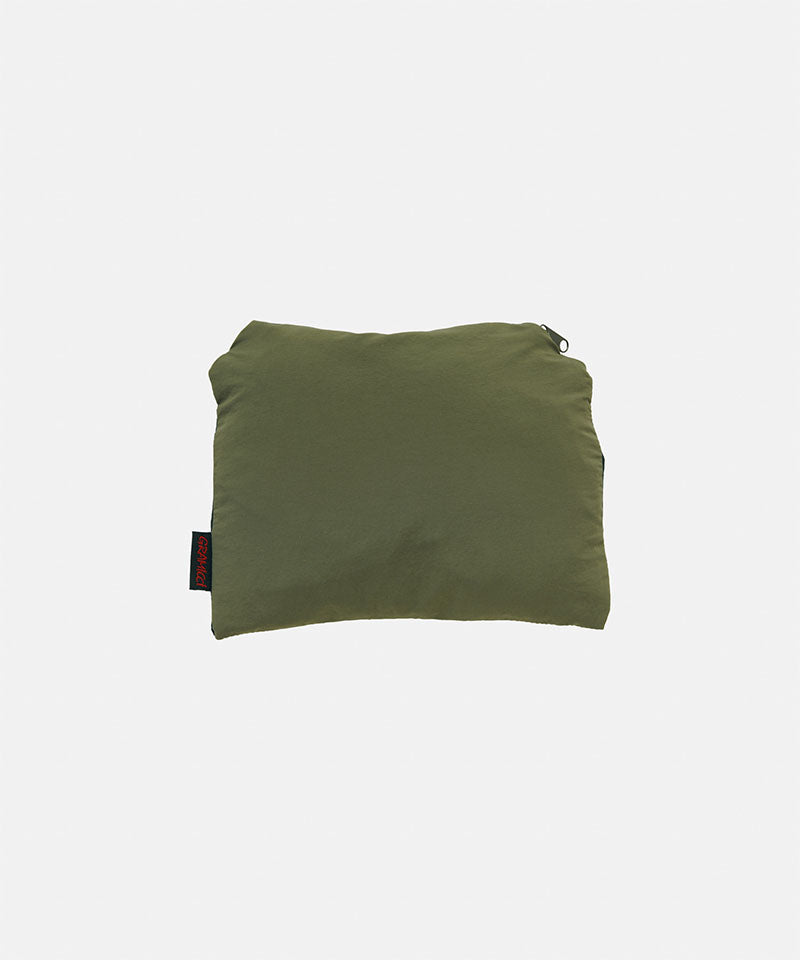 Folded green fabric skirt pack on a light gray background