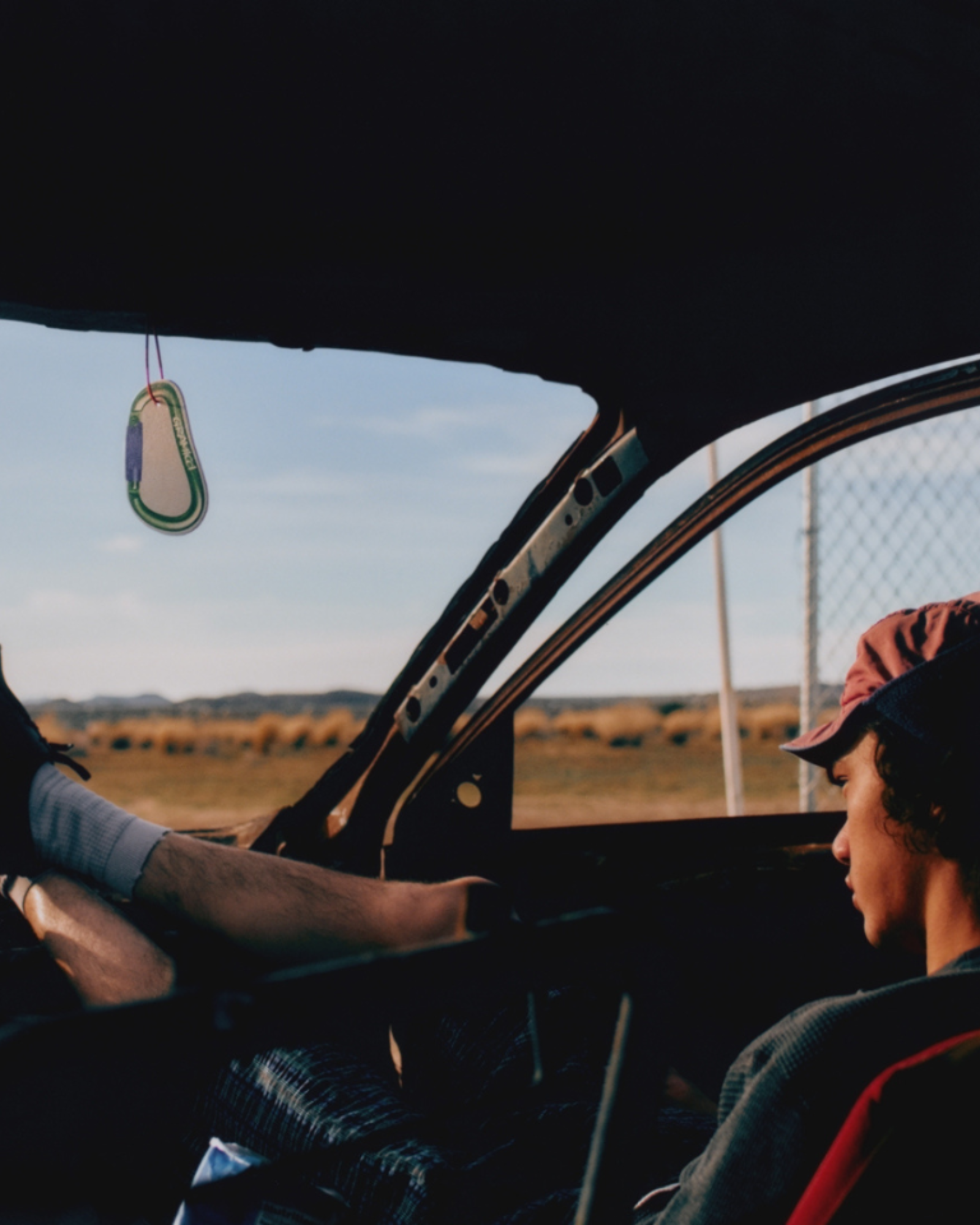 Two people in a car with a scenic view outside
