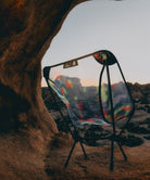 Mesh Camo bright colored Gramicci & Helinox Chair One camping chair with a desert landscape looking out from a cave.
