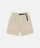 Sand pigment dye Gramicci G-Shorts with a belt against a light-tone background.