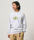 Model wearing a Gramicci ash heather colored Flames Long Sleeve Tee with a graphic against a light-tone background.