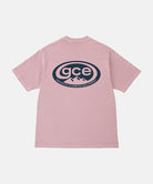 Back view of a Gramicci lilac pigment colored GCE Tee Pigment Dyed with a graphic against a light-tone background.