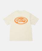 Back view of a Gramicci natural pigment colored GCE Tee Pigment Dyed with a graphic against a light-tone background.