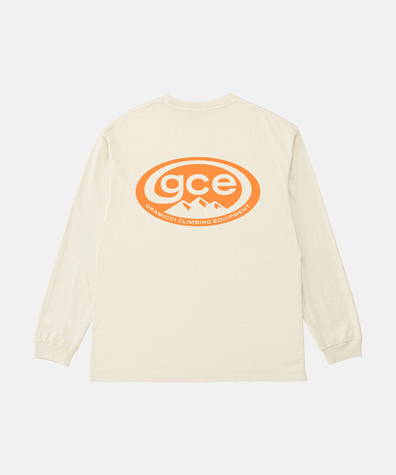 Back view of a Gramicci natural pigment colored GCE Long Sleeve Tee Pigment Dyed with a graphic against a light-tone background.