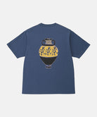 Back view of a Gramicci navy Vase Tee with a graphic against a light-tone background.