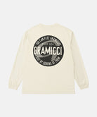 Back view of a Gramicci natural pigment colored Icon Long Sleeve Tee Pigment Dyed with a graphic against a light-tone background.