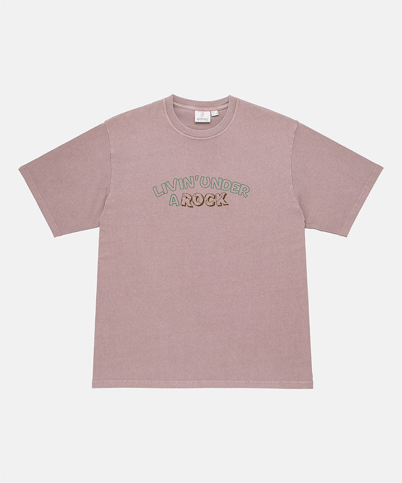 Gramicci lillac pigment colored Livin' Tee Pigment Dyed with a Livin' Under A Rock graphic against a light-tone background.