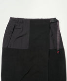 Close-up view of a black Gramicci Thermal Fleece Skirt against a light-tone background.