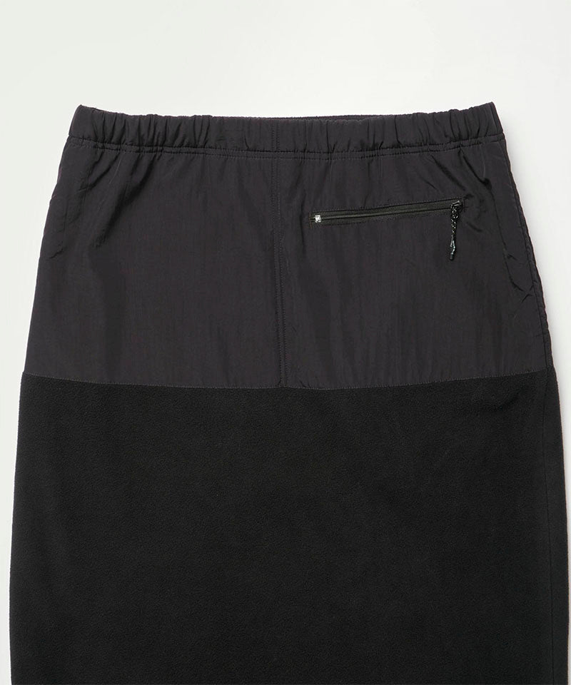 Back view close-up of a black Gramicci Thermal Fleece Skirt against a light-tone background.