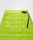 Close-up view of a lime colored Gramicci G-Zero Primaloft Skirt against a light-tone background.