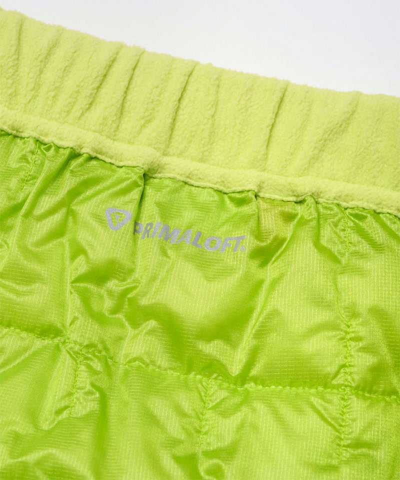 Close-up view of a lime colored Gramicci G-Zero Primaloft Skirt against a light-tone background.