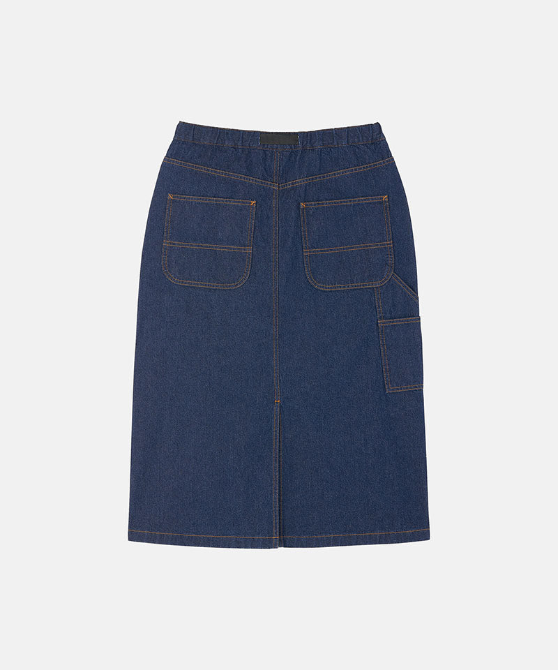 Back view of a rinsed indigo Gramicci Denim Carpenter Skirt against a light-tone background.