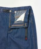 Close-up of the waistband on a stone colored Gramicci Gramicci Denim Carpenter Skirt on a light-tone background.