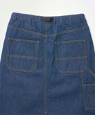 Back view close-up of a stone colored Gramicci Denim Carpenter Skirt against a light-tone background.