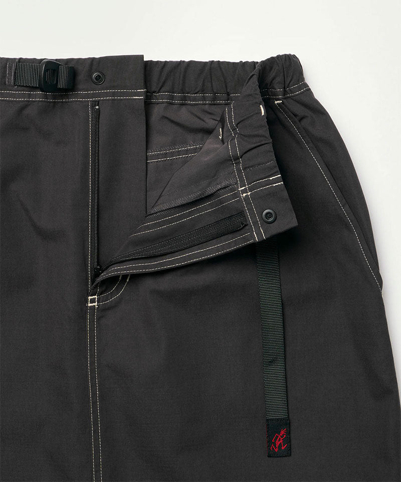 Close-up of the waistband on a black Gramicci women's Gramicci WR Convertible Skirt on a light-tone background.