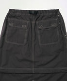 Back view close-up of a black women's Gramicci WR Convertible Skirt against a light-tone background.