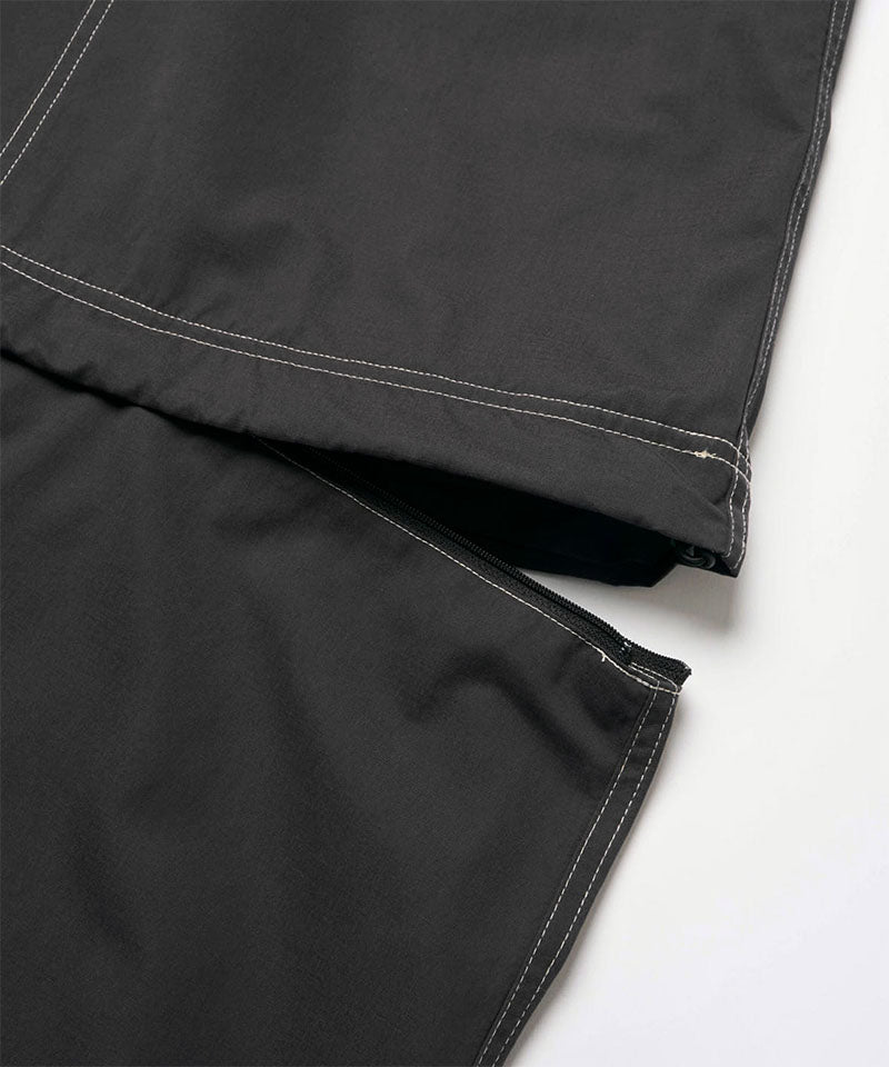 Close-up view of a black women's Gramicci WR Convertible Skirt against a light-tone background.