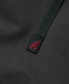 Close-up view of a black women's Gramicci WR Convertible Skirt belt with logo.