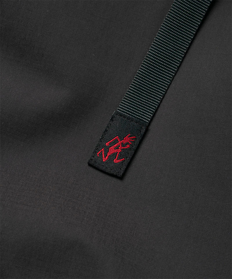 Close-up view of a black women's Gramicci WR Convertible Skirt belt with logo.