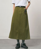 Olive colored Gramicci 5-Pocket Skirt against a light-tone background.