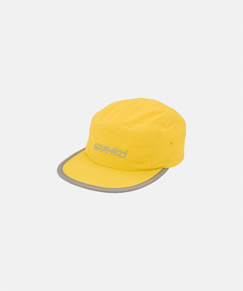 Banana colored Nylon Gramicci Cap
with a gray brim on a light tone background.