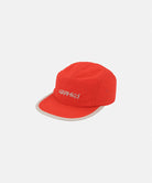 Orange cap with 'Gramicci' logo on a light tone background