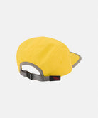 Back view of a Banana colored Nylon Gramicci Cap with a gray brim on a light tone background.