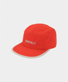 Burnt orange Nylon Gramicci Cap
with a light grey 'Gramicci' logo on a light tone background.