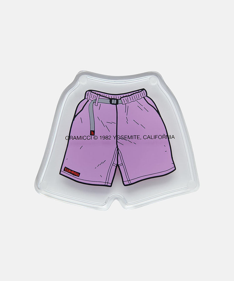 Small tray with purple Gramicci shorts with a belt against a light-tone background
