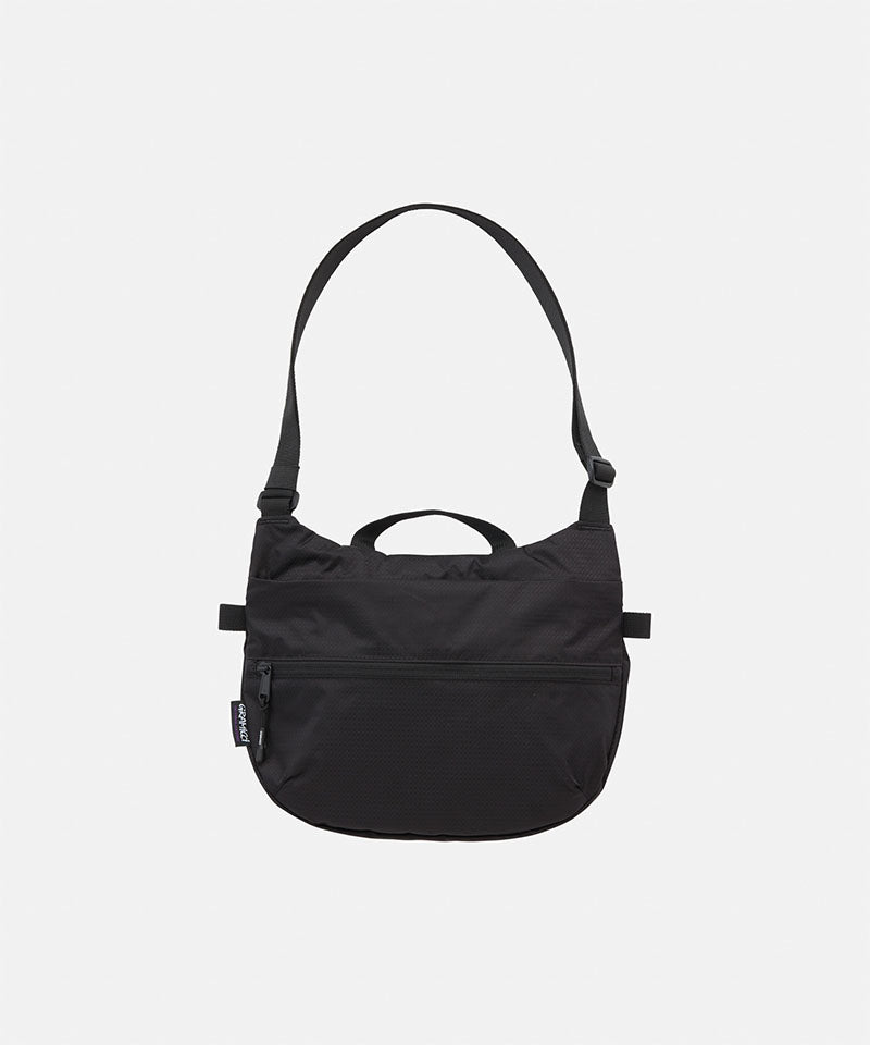 Black Gramicci Field Sacoche bag against a light-tone background.