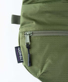 Close-up of Gramicci Field Sacoche bag in the color olive against a light-tone background.