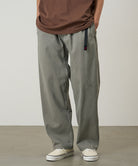 Model wearing a Natural Dyed Gramicci Pant Straight Fit in the color olive on a light-tone background.
