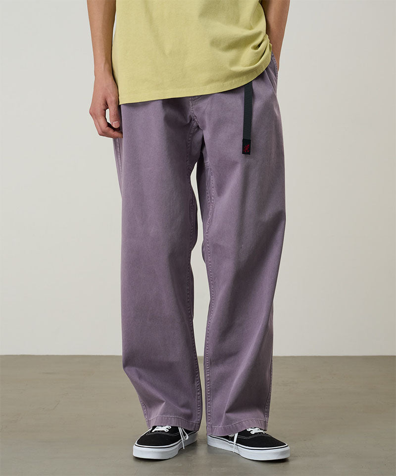 Model wearing a Gramicci purple Natural Dyed Gramicci Pant Straight Fit against a light-tone background.
