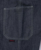 Back view close-up of Japanese Chambray Rock Slide Pants pocket in the color navy against a light-tone background.