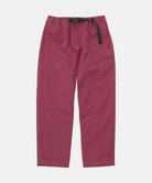 Gramicci Milton Pants in burgundy with a black belt against a light-tone background.
