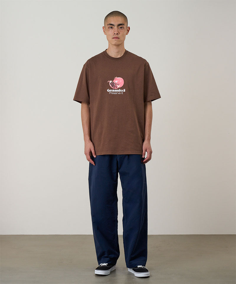 Model wearing dark navy Gramicci Milton Pants and a brown shirt on a light-tone background.