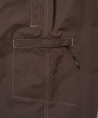 Close-up of Gramicci Milton Pants in the color walnut against a light-tone background.
