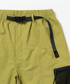 Green shorts with a black belt and zipper pocket on a white background