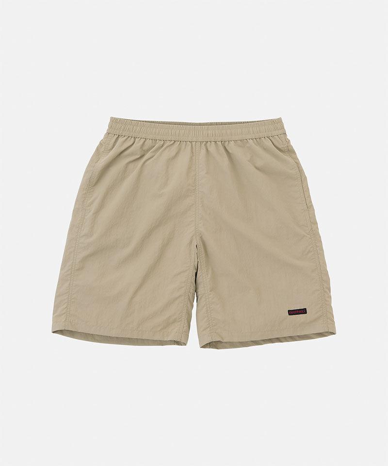 Beige shorts with a small logo on a light gray background
