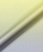 Close-up of a checkered fabric with a gradient from yellow to grey.