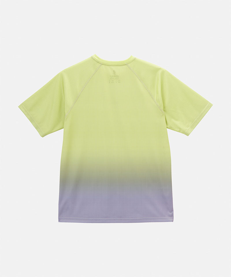 Back view of a Gramicci yellow gradient UPF Shield S/S Top with a white Gramicci graphic against a light-tone background.
