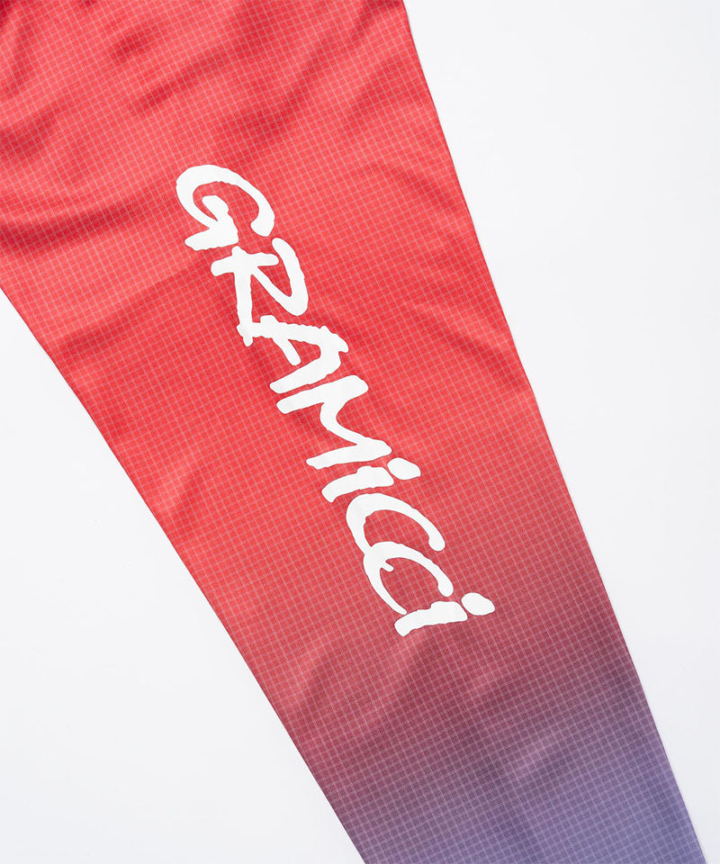 Red and blue gradient UPF Shield S/S Top sleeve with 'Gramicci' branding