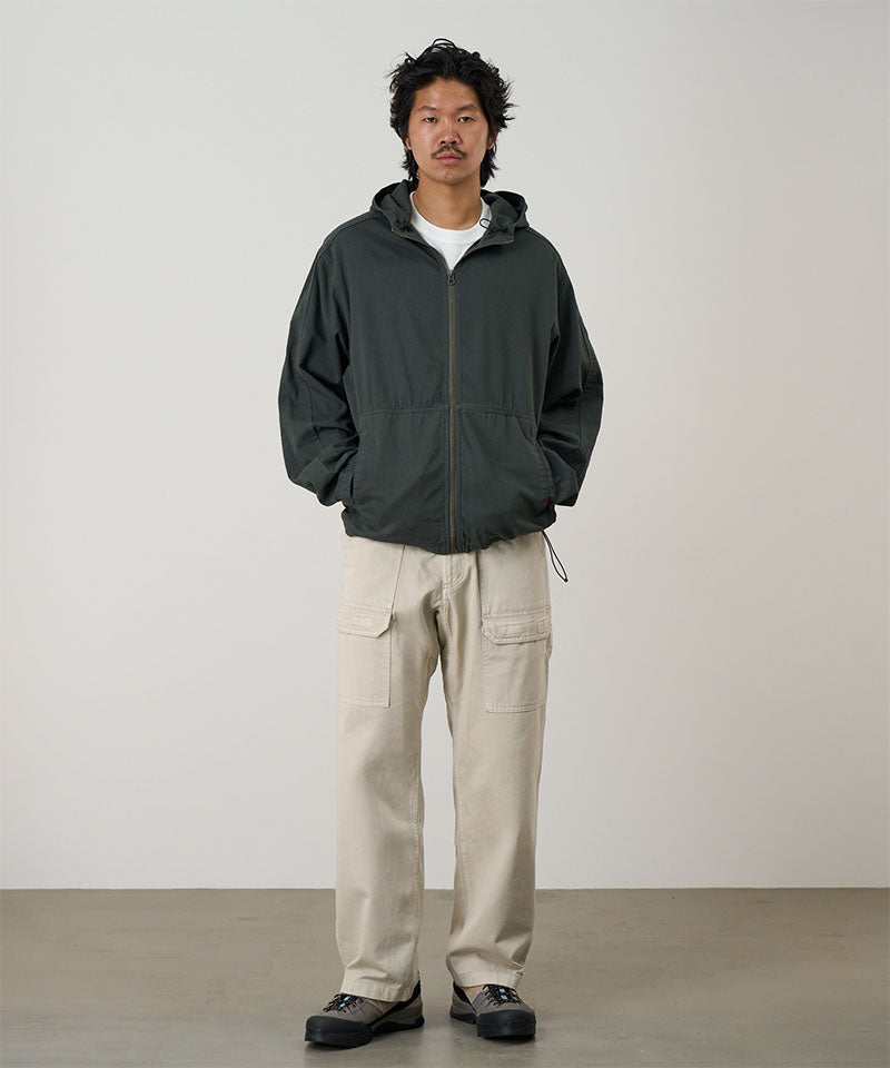 Model wearing the Gramicci Beach Hoodie Jacket in shadow with tan cargo pants on a light tone background.