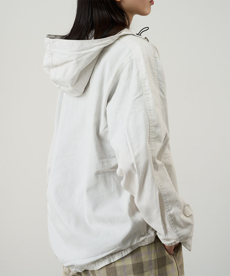Side view of a model wearing the Gramicci Beach Hoodie Jacket in stone on a light tone background.