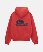 Red hoodie with Gramicci logo on the back against a light gray background