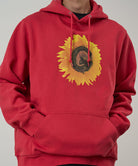Red hoodie with a sunflower design on a plain background